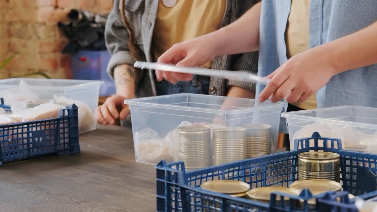 Volunteers pack bags of groceries at a food pantry.